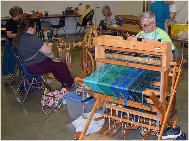 Jim Crabtree, of the Aurora Colony Guilds team, Crazy Sheep at the Wheel, at the loom. Photo: Rich Lundquist.